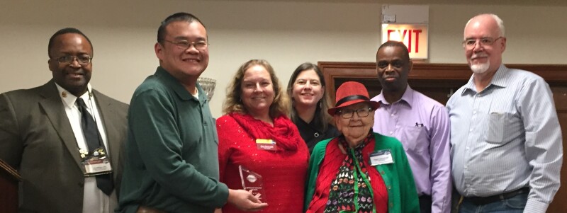 UOP Riverside Toastmasters club officers accepting Distinguished Club award